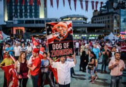 A Pro-Erdogan supporter holds a portrait of US-based cleric Fethullah Gulen during a rally against the military coup on Taksim square in Istanbul on July 25, 2016.
Turkey detained seven fugitive soldiers on July 25 on suspicion of taking part in an attack on the hotel where President Recep Tayyip Erdogan was staying when the failed coup kicked off.  / AFP / OZAN KOSE        (Photo credit should read OZAN KOSE/AFP/Getty Images)